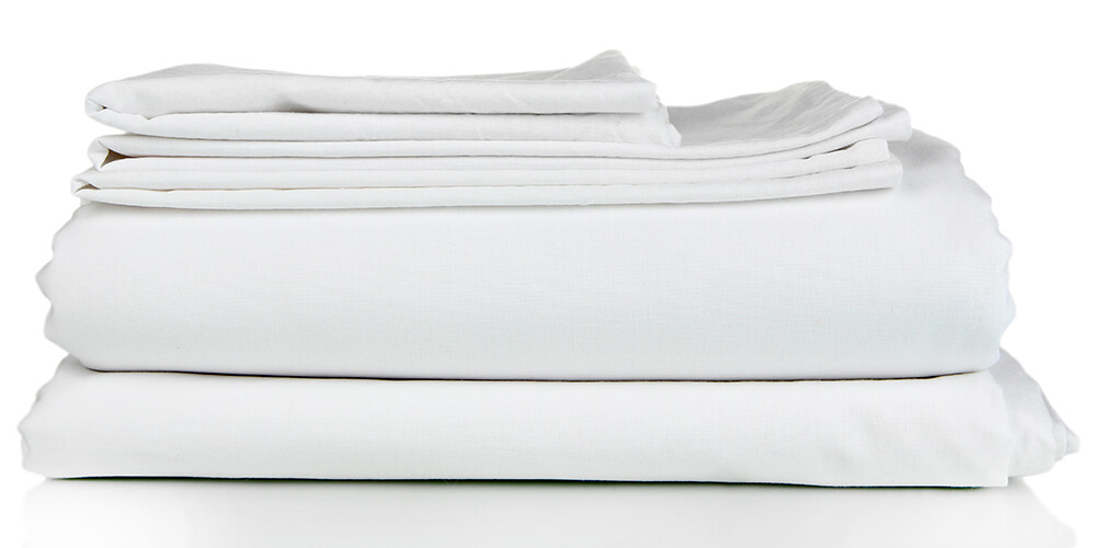 Stacked white bedsheets